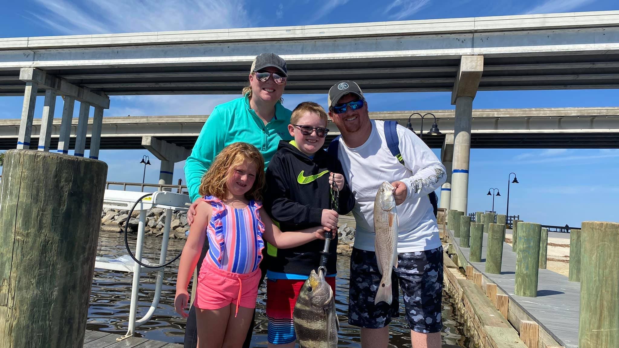 Portrait of a happy family caught two fish